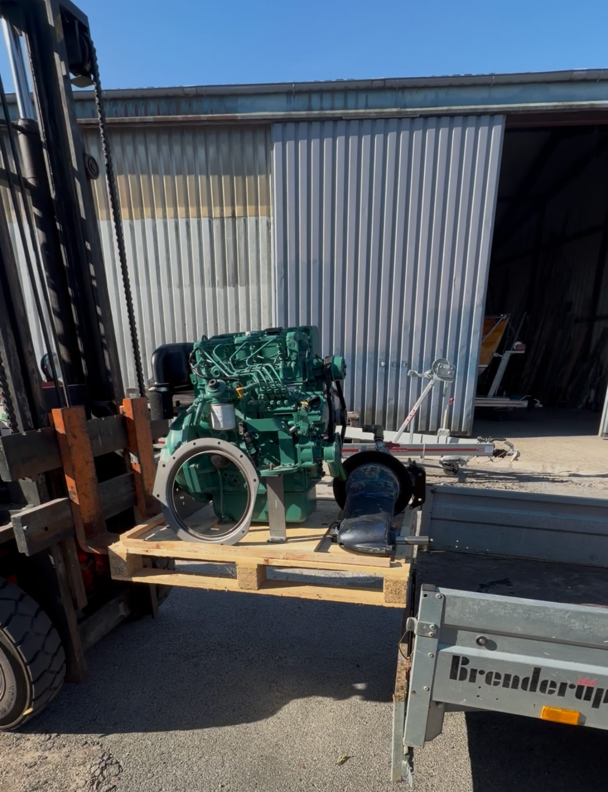 A used marine diesel engine strapped to a pallet
