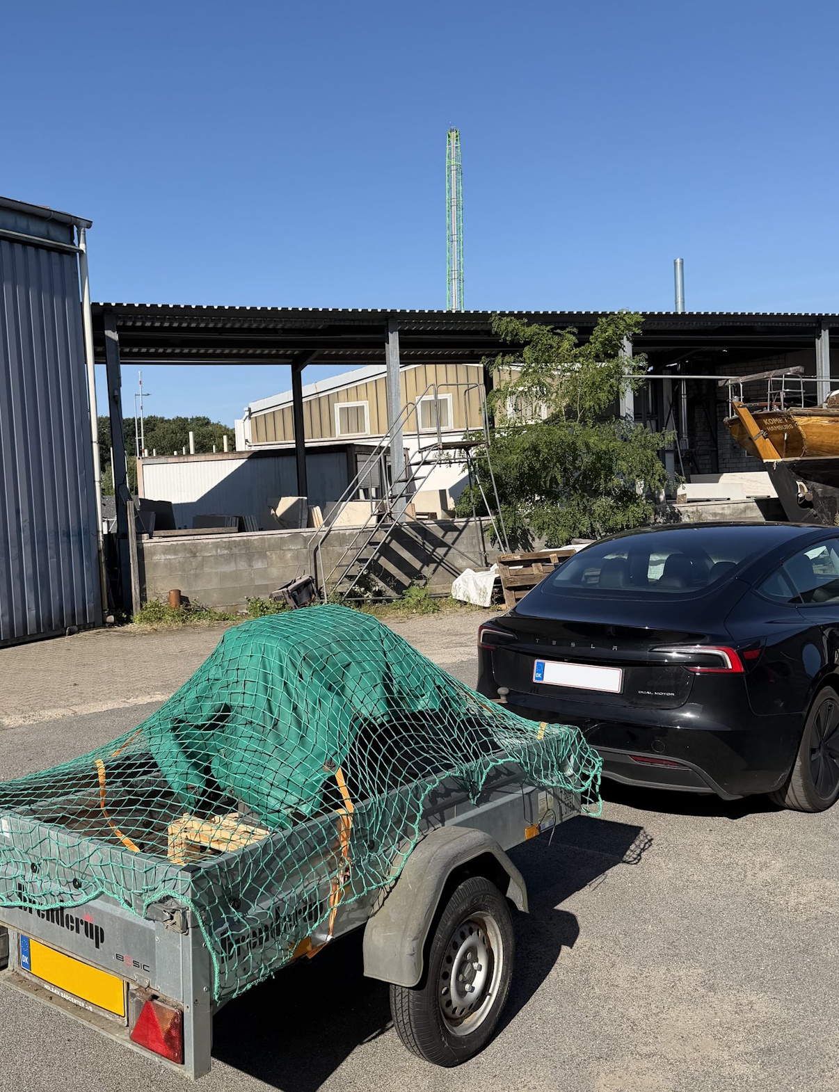 The engine on a trailer behind the tow car